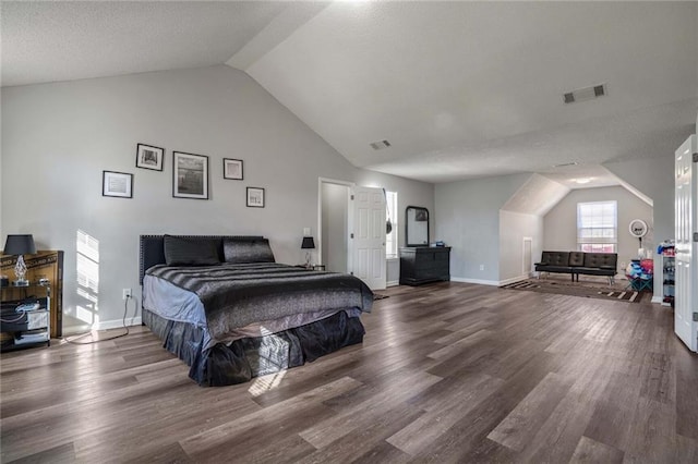 bedroom featuring dark wood-type flooring and lofted ceiling