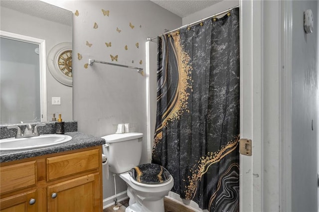 bathroom featuring vanity, toilet, and a textured ceiling