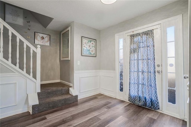 foyer with wood-type flooring and a wealth of natural light