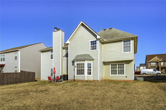 rear view of property with a yard