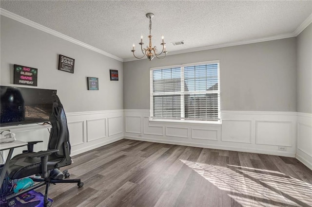 unfurnished office featuring an inviting chandelier, hardwood / wood-style floors, crown molding, and a textured ceiling