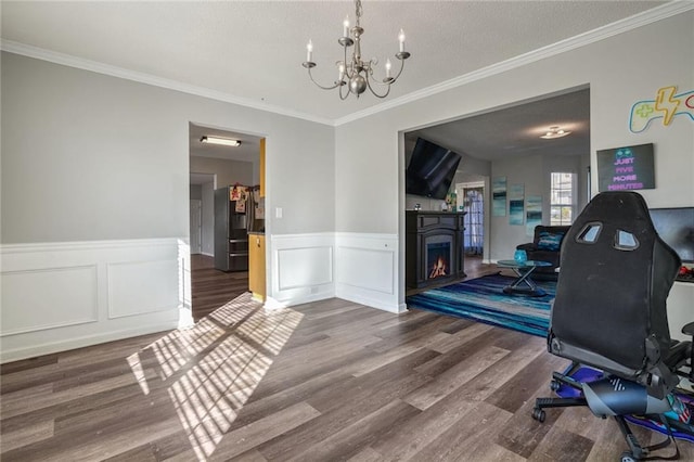 dining space featuring a notable chandelier, ornamental molding, and dark hardwood / wood-style floors