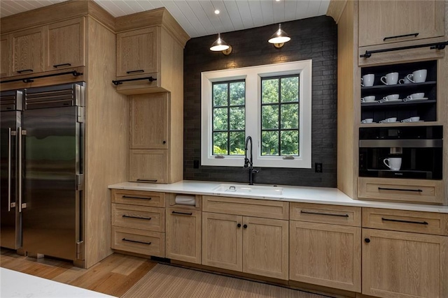 170 Autry Trl, Johns Creek, GA 30022 - kitchen featuring built in fridge, light wood finished floors, light countertops, light brown cabinets, and pendant lighting