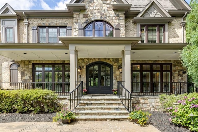 170 Autry Trl, Johns Creek, GA 30022 - view of exterior entry with french doors, covered porch, and stone siding