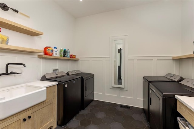 170 Autry Trl, Johns Creek, GA 30022 - washroom with independent washer and dryer, a decorative wall, cabinet space, wainscoting, and dark tile patterned floors