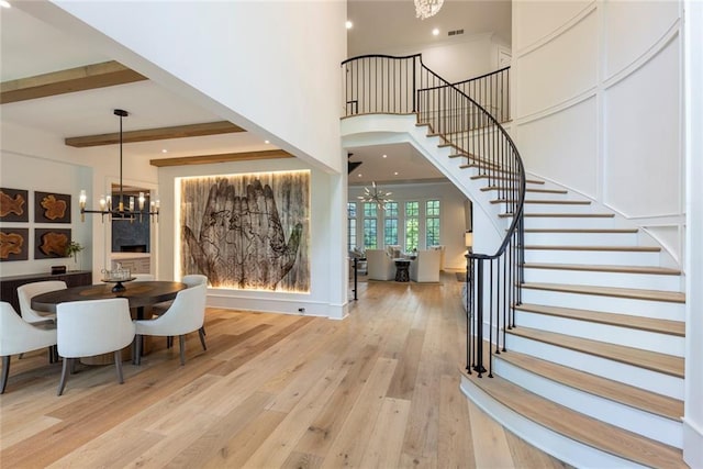 170 Autry Trl, Johns Creek, GA 30022 - dining area with a chandelier, stairs, light wood-style floors, a towering ceiling, and beam ceiling