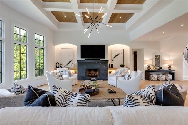 170 Autry Trl, Johns Creek, GA 30022 - living area with coffered ceiling, a chandelier, beam ceiling, arched walkways, and a high end fireplace