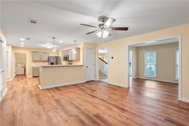 kitchen with visible vents, light countertops, light wood finished floors, and appliances with stainless steel finishes