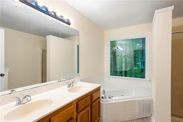 bathroom with a sink, a jetted tub, a stall shower, and double vanity