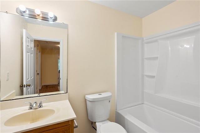 full bathroom with toilet and vanity