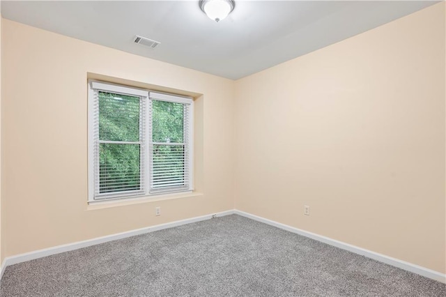unfurnished room featuring carpet flooring, baseboards, and visible vents