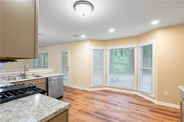 kitchen featuring stainless steel dishwasher, baseboards, recessed lighting, a sink, and light wood finished floors