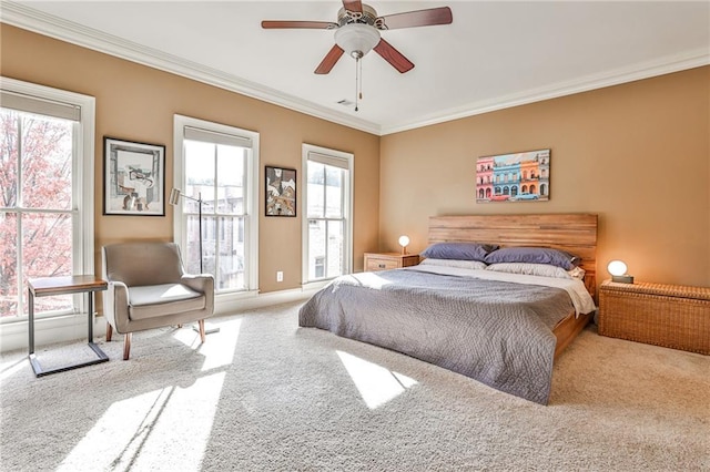 carpeted bedroom featuring ceiling fan and ornamental molding