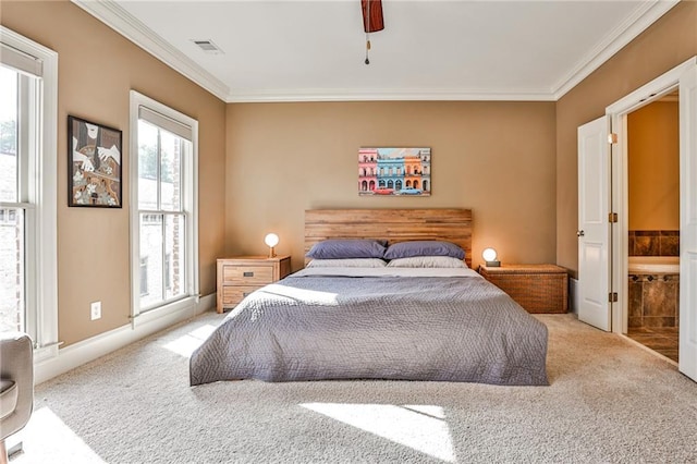 carpeted bedroom featuring ensuite bath, ceiling fan, and crown molding