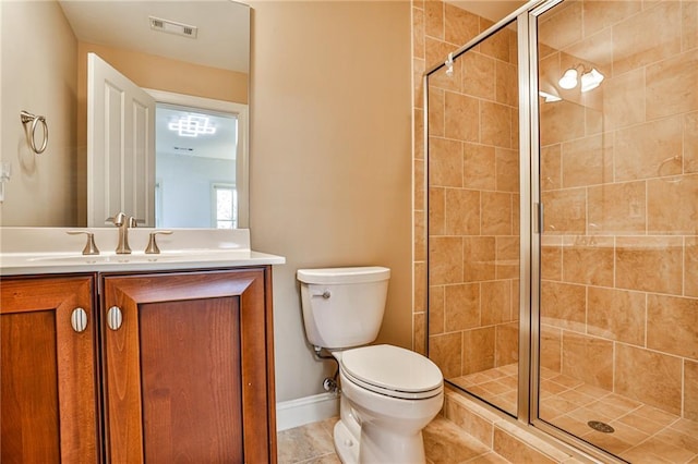 bathroom featuring toilet, tile patterned floors, walk in shower, and vanity