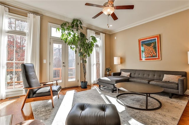 sitting room featuring light hardwood / wood-style flooring, french doors, and crown molding