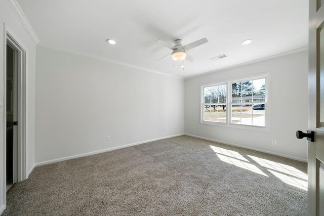 carpeted spare room featuring visible vents, crown molding, baseboards, and ceiling fan