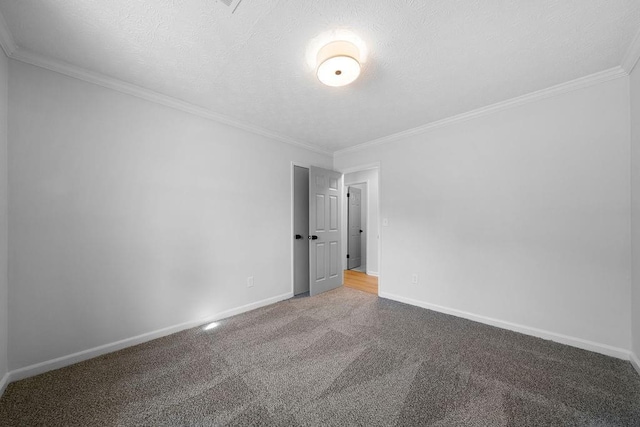 unfurnished room with carpet, baseboards, a textured ceiling, and ornamental molding