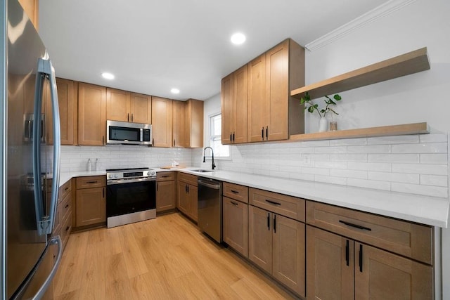 kitchen with a sink, light wood-style floors, appliances with stainless steel finishes, backsplash, and open shelves