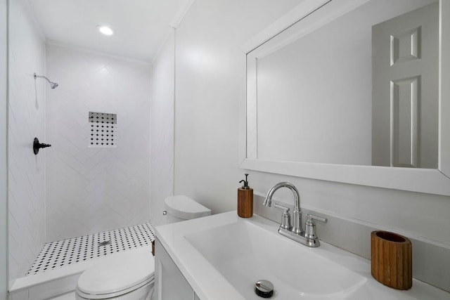 bathroom with vanity, a shower stall, toilet, and crown molding