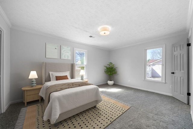 carpeted bedroom featuring ornamental molding, multiple windows, visible vents, and baseboards