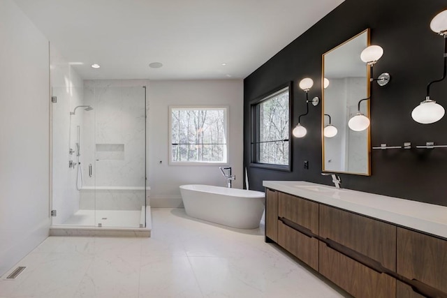 full bath with marble finish floor, vanity, a soaking tub, visible vents, and a stall shower