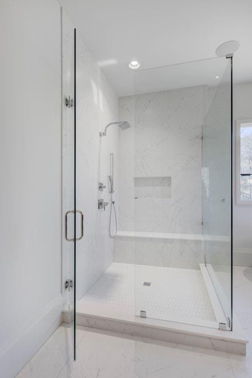 full bathroom featuring recessed lighting, marble finish floor, and a marble finish shower