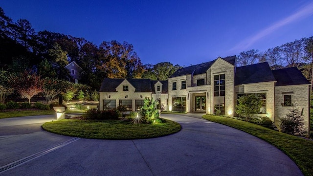 french country inspired facade with curved driveway