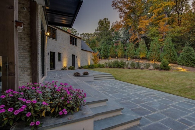 view of home's community featuring a patio area and a yard