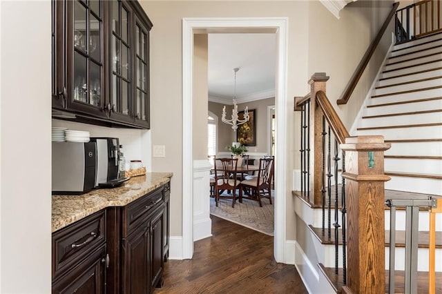 bar with stairway, baseboards, ornamental molding, and dark wood finished floors