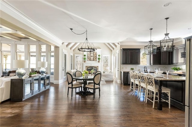 dining space featuring a chandelier, dark wood-type flooring, and plenty of natural light