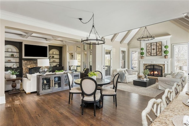 dining room with an inviting chandelier, dark wood-type flooring, and a stone fireplace