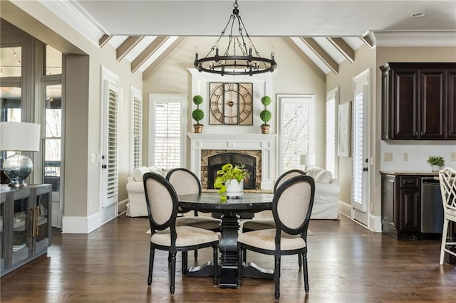 dining room featuring vaulted ceiling with beams, dark wood-style floors, a fireplace, and a chandelier