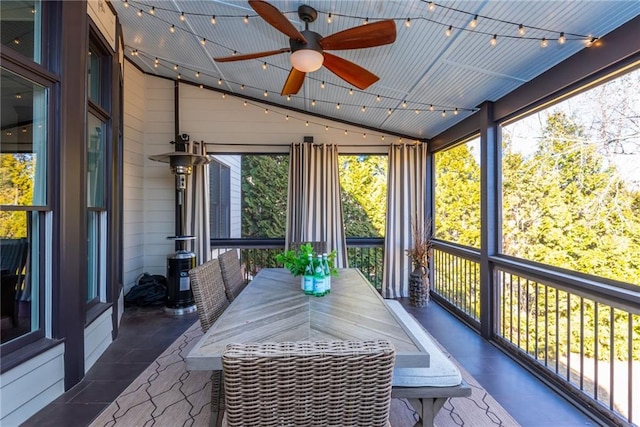 sunroom featuring a ceiling fan, lofted ceiling, and track lighting