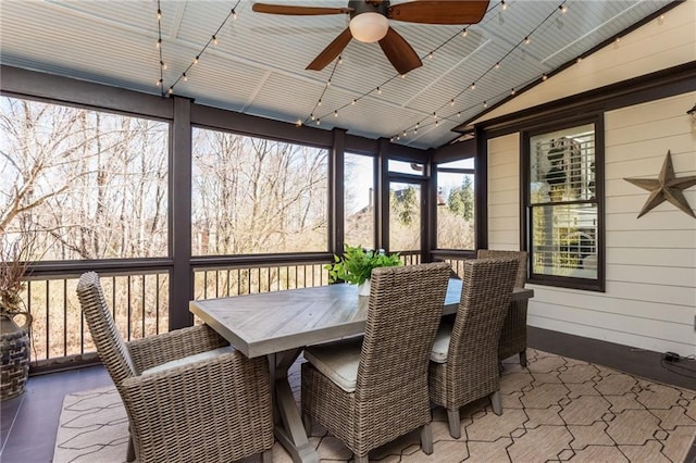 sunroom / solarium with lofted ceiling and a ceiling fan