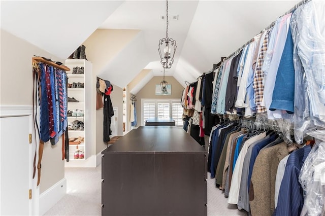 walk in closet featuring light carpet and vaulted ceiling