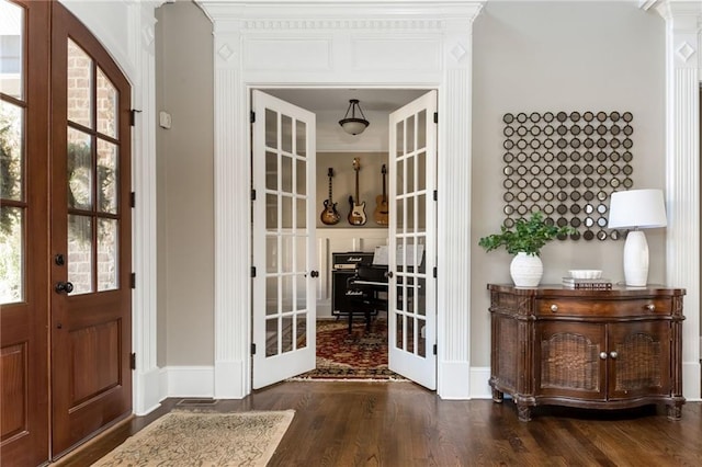 interior space featuring french doors, dark wood finished floors, and baseboards