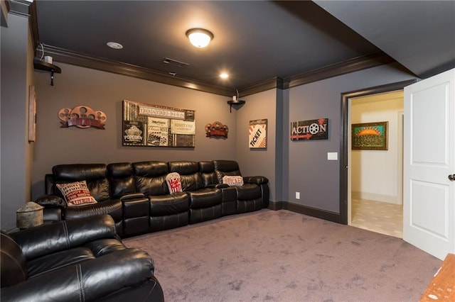 carpeted home theater room featuring baseboards, visible vents, and crown molding