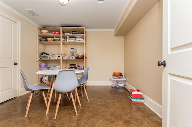 dining room with concrete flooring, crown molding, visible vents, and baseboards