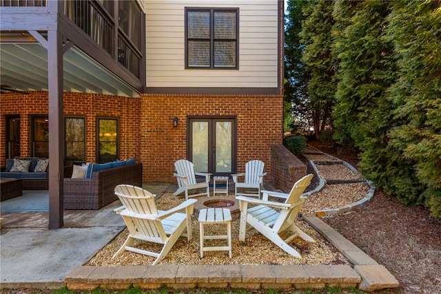 view of patio with french doors and an outdoor living space with a fire pit