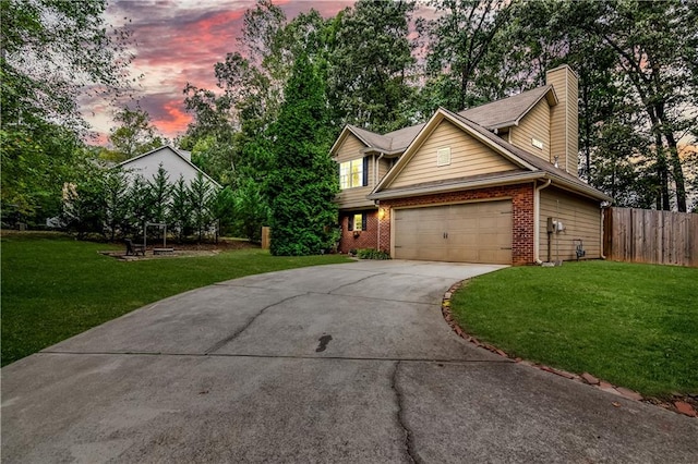 view of front of property featuring a garage and a lawn