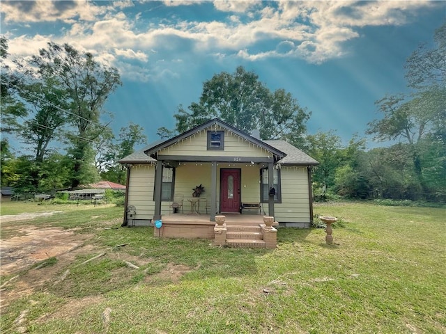 bungalow featuring a front lawn and a porch