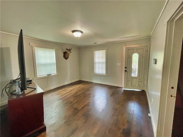 foyer entrance with crown molding and dark hardwood / wood-style floors