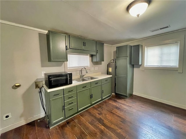 kitchen featuring sink, a wealth of natural light, dark hardwood / wood-style floors, and green cabinets