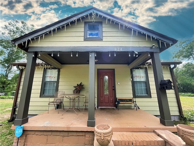 back of house featuring a porch