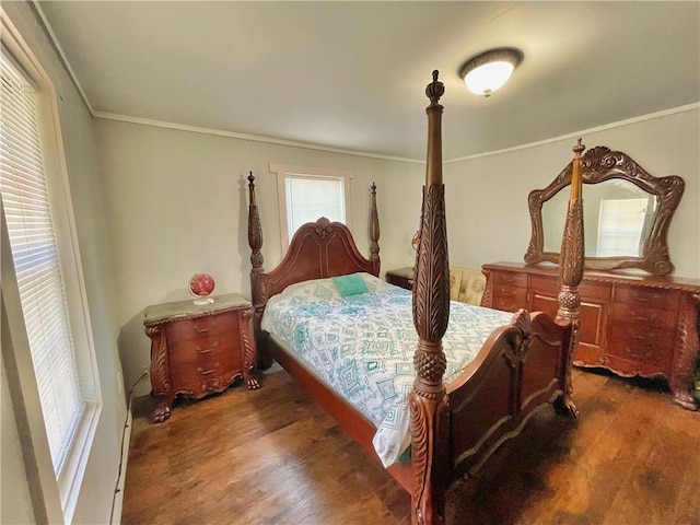 bedroom with dark wood-type flooring and ornamental molding