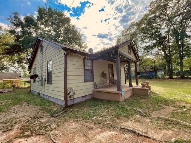 view of side of home featuring a lawn