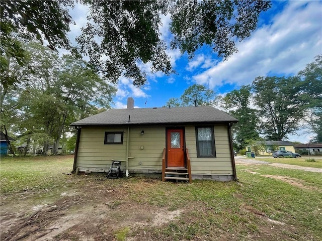 back of property with a yard