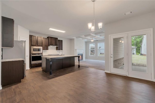 2320 Ivy Birch Ln, Buford, GA 30519 - kitchen with appliances with stainless steel finishes, open floor plan, dark brown cabinets, light countertops, and dark wood-type flooring