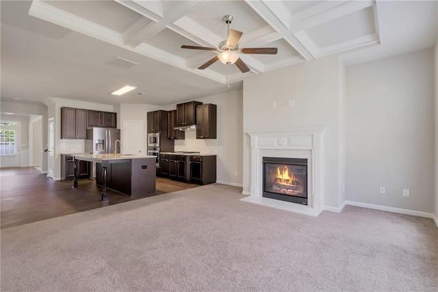 2320 Ivy Birch Ln, Buford, GA 30519 - unfurnished living room featuring coffered ceiling, carpet floors, a sink, a fireplace with flush hearth, and baseboards